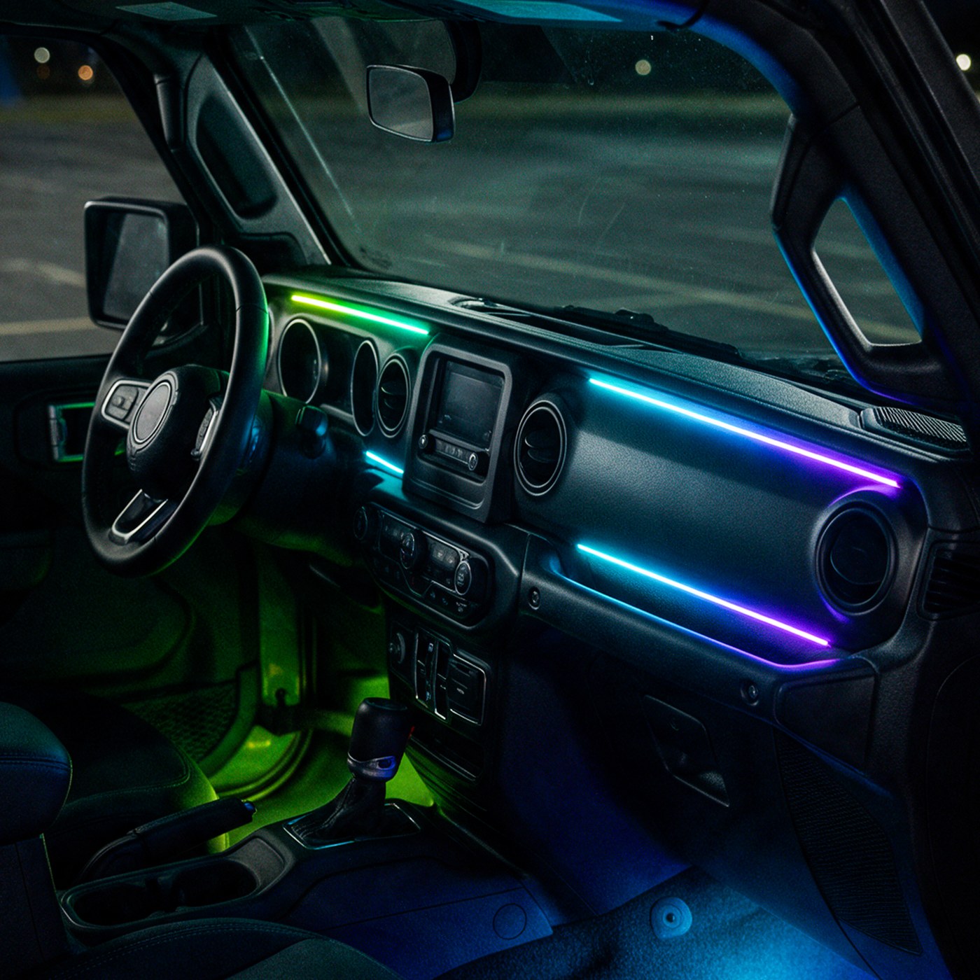 Jeep Wrangler JL dashboard with fiber-optic lines glowing green, blue and purple