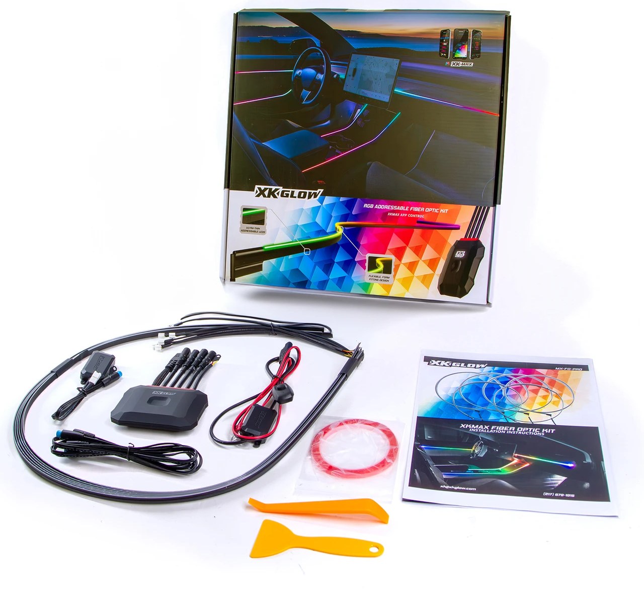 Fiber-optic interior kit laid out with its box, controller, wiring, fiber strip, adhesive tape, and two pry tools